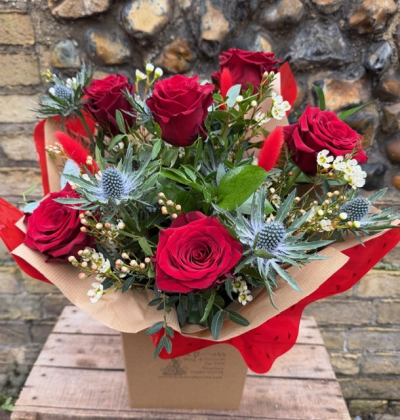 Six Stolen Kisses - Six of the best red freedom roses mixed with seasonal foliage, waxflower and thistle.