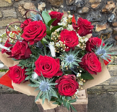 Dramatic Dozen - Twelve beautifully handtied red roses delivered gift wrapped and in water to the door, a beautifully romantic gift.