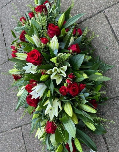Rose and Lily Casket Spray - A floral casket display of scented oriental lilies with stunning large headed roses, delicate spray roses and seasonal foliage. Standard size 3ft, medium 4ft, large 5ft. Alterations to colours and sizing available on request.