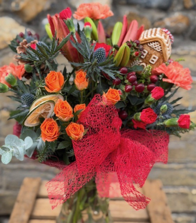 Gingerbread Vase - A beautiful Christmas vase with scented seasonal foliage and bold winter blooms, perfect for sending warm wishes this season, the freshest flowers arranged in a glass vase by your local florist, completed with a ceramic gingerbread decoration. 
Available for same day delivery.