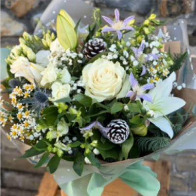 Frosty Morning Handtie - A beautiful display of the freshest blooms in cool winter tones including roses and lilies with a selection of scented foliage, hand crafted by your local florist. A gorgeous gift for the season delivered in water to the door. 
Available for same day delivery.