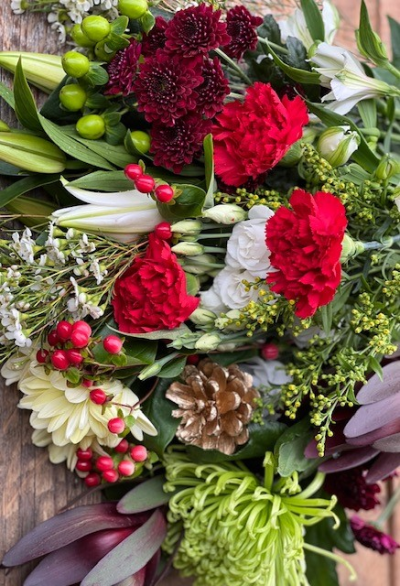 Florist Choice Christmas Bouquet - A selection of fresh seasonal festive blooms chosen by your local florist, beautifully gift wrapped and delivered to the door.