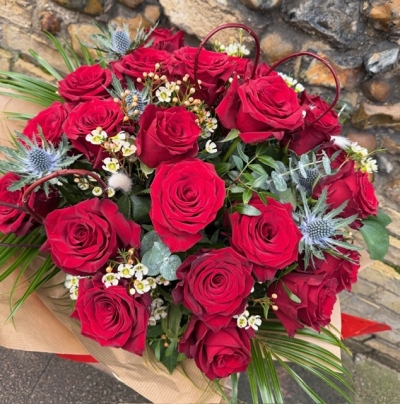 Stunning Twenty-four - A breathtaking display of twenty-four beautiful large headed red roses, with seasonal foliage, thistle and scented waxflower.